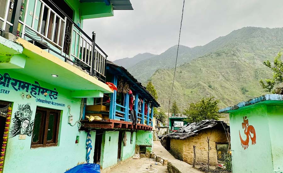 Traditional homestay in Urgam village surrounded by Himalayan hills and green fields